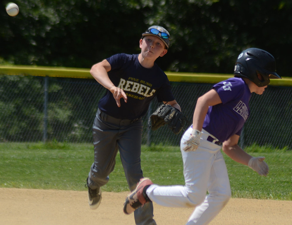 Pine Bush Rebels shortstop Connor Amiel makes a throw after looking the runner back to first base during Saturday’s Greater Hudson Valley Baseball League 10U Division 3 playoff game at Pine Bush Town Park.